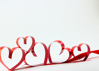 Ribbons shaped as hearts on white background, valentine day conc