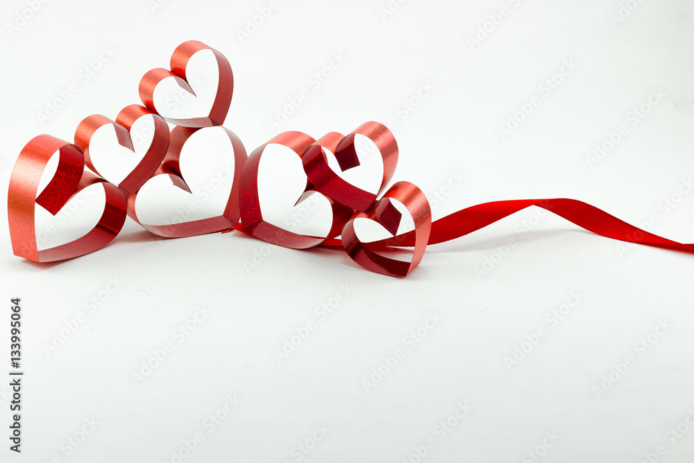 Wall mural ribbons shaped as hearts on white background, valentine day conc