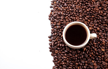 Coffee beans in coffee cup isolated on white