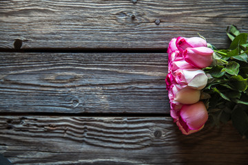 Pink roses bouquet over wooden table. Top view with copy space. flowers