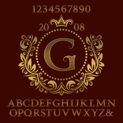 Golden lattice patterned letters and numbers with initial monogram in coat of arms form. Decorative font and elements kit for logo design.