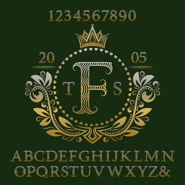 Golden wavy patterned letters and numbers with initial monogram in coat of arms form. Elegant font and elements kit for logo design.
