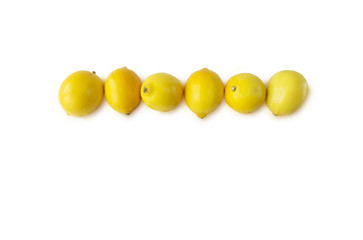 Lemons at border of image with copy space for text. Top view. Ripe lemons close-up on a white background. Background citrus.