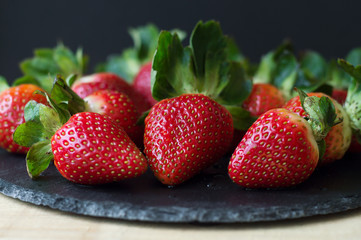 Fresh strawberry on black slate board. Healthy eating concept