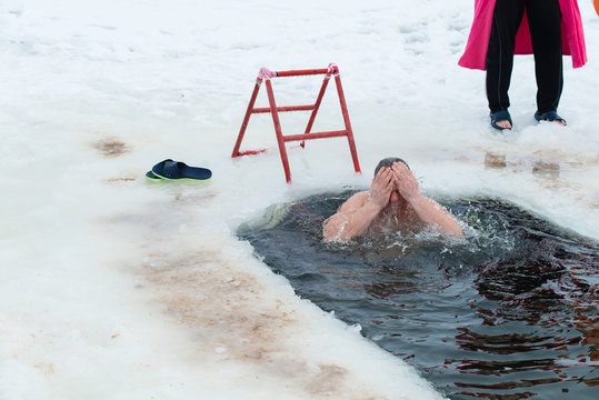 swimming in icy water, christening, baptism in Russia