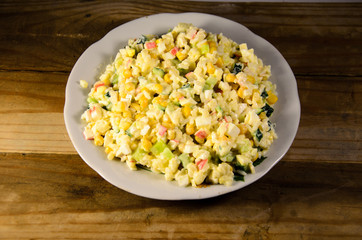 Salad with crab sticks, corn, cucumber, and eggs