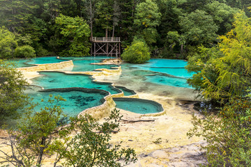 Huanglong National Park, Sichuan, China, famous for its colorful pools formed by calcite deposits. Situated at more than 3000m elevation, it is a UNESCO World heritage site