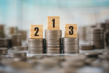 Stack of Coins with Wooden Letters