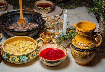 Traditional Ukrainian food.Kutya, borsch, dumplings, cabbage rolls on festive table.
