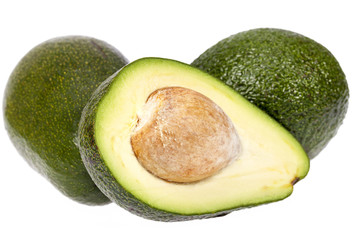 Half and whole avocado with stone isolated on white background