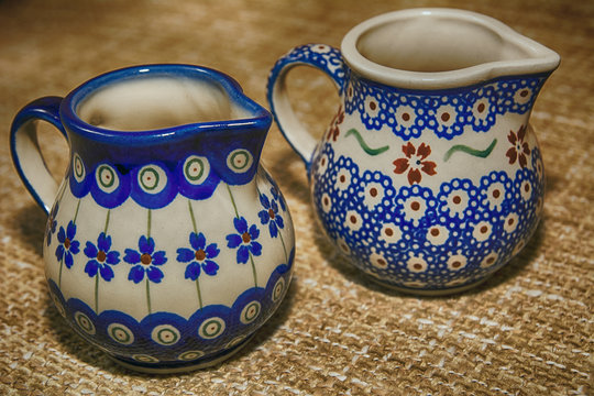 Ceramic jug for milk on the fabric