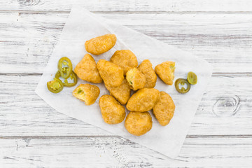 Chili Cheese Nuggets (selective focus) on vintage wooden backgro