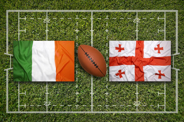 Ireland vs. Georgia flags on green rugby field