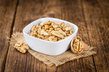 Cracked Walnuts on wooden background (selective focus)