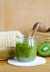 Homemade kiwi fruit beauty mask (scrub) in a glass jar. DIY cosmetics.