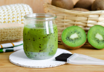 Homemade kiwi fruit beauty mask (scrub) in a glass jar. DIY cosmetics.
