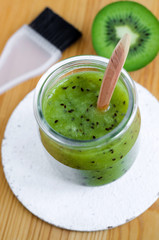 Homemade kiwi fruit beauty mask (scrub) in a glass jar. DIY cosmetics.