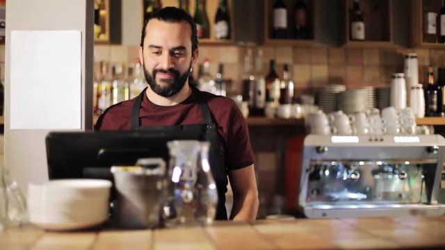 happy man or waiter at cashbox in coffee shop