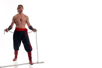 Actor Athlete man in trousers with naked torso training with chain on white background