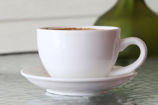 White coffee mug on table.
