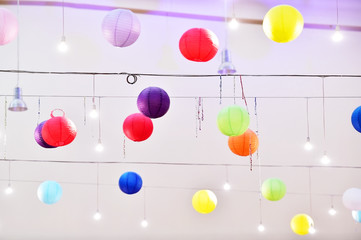 Colorful lantern lampions hanging on a ceiling