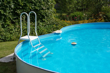 Pool equipment: a thermometer and a vacuum cleaner brush