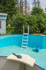 Pool equipment: a thermometer and a vacuum cleaner brush