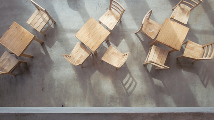 Wood tables and chairs on concrete floor
