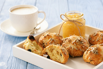 Home breakfast - homemade cheese bread rolls with cranberries, almond ans sunflower seeds and cup of coffee.