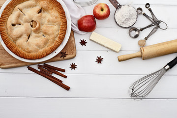 Apple Pie with Ingredients Over Wooden Table Top