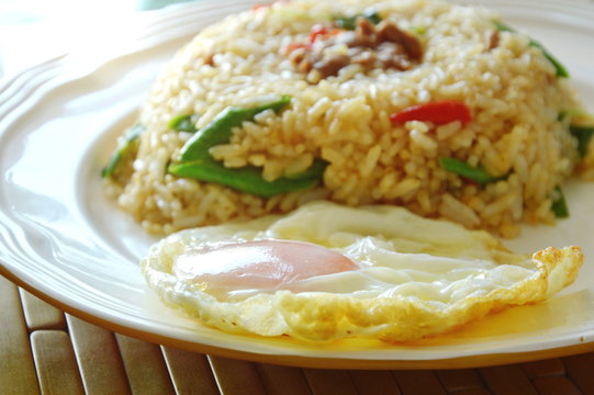 spicy fried rice pork and basil leaf with fried egg on dish