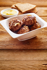 Serving of German frikadelle with mustard