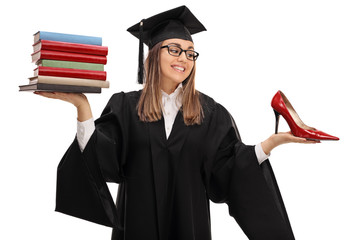 Tempted graduate student holding stack of books and shoe