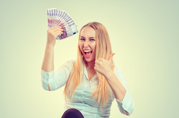 Woman happy holding money.