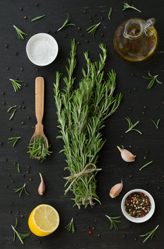 Bunch of rosemary with garlic, olive oil and spices