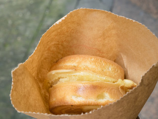 The close up of Japanese red bean cake dessert in brown paper bag.