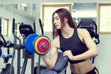Fototapeta premium Girl is engaged in sports and gymnastics in the gym