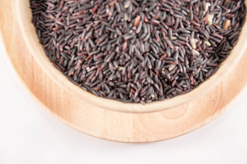 The Organic rice in wooden bowl. The purple rice organic in wooden bowl.