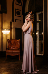 Young woman in long silk dress