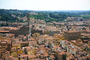 Fototapeta na wymiar View of Florence from the observation deck of the dome of the cathedral Santa Maria del Fiore in Florence, Italy. Mosaic of houses, roofs and windows.