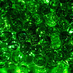 Green balls hydrogel in a glass.Bright abstract colorful background