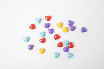 Miniature plastic hearts love on white background