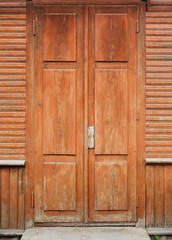 Entrance door of the old wooden house of red color