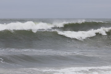 Strong waves crashing before arriving to the shore.