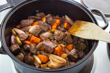 Meat stew closeup in cast iron dutch owen lid removed