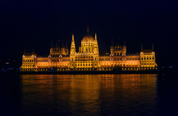 Fototapeta na wymiar View on the illuminated Parliament of Budapest across the river Danube on a winter night