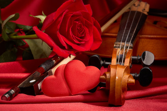 Violin, red rose and heart.
