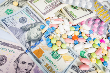 Money and pills. Pills of different colors on money. medicine co