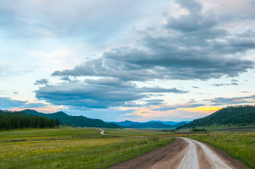 Obraz premium Road in the mountains at sunset