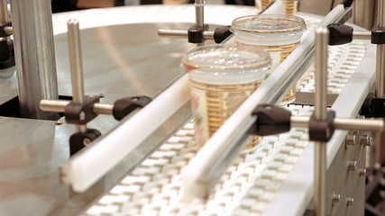 Conveyor product line for packing and marking goods and food packs. Robotics and automatic lines instead of human labor on factories and plants.